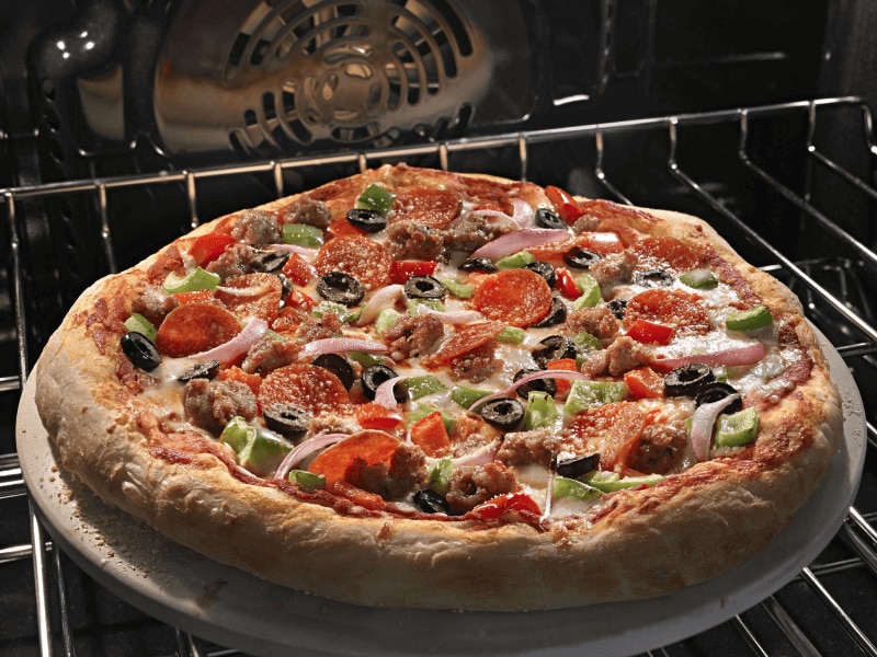 Pizza cooking in an oven