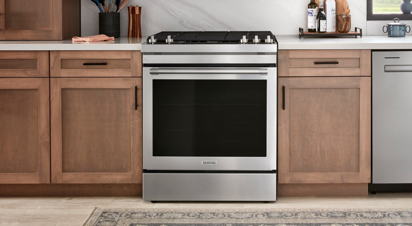 A Maytag® oven in a kitchen with brown cabinets