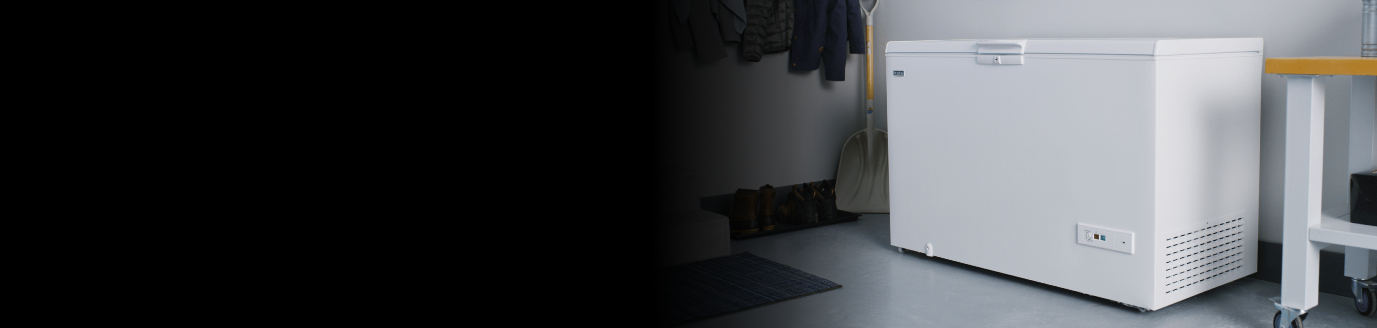 A white Maytag® chest freezer in a storage room