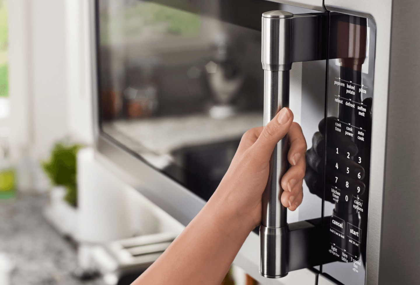 Hand on a Maytag® convection microwave. Hand on a Maytag® convection microwave.