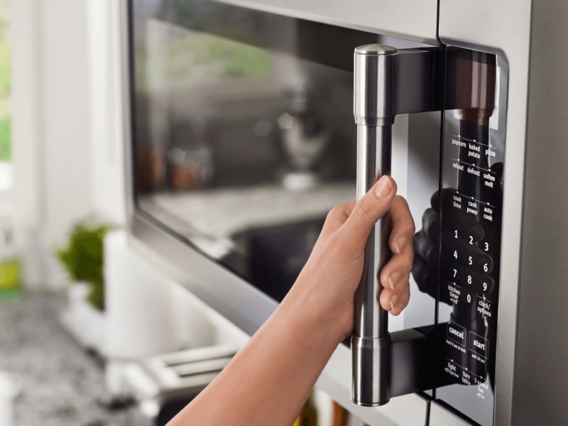 Hand on a Maytag® convection microwave. Hand on a Maytag® convection microwave.