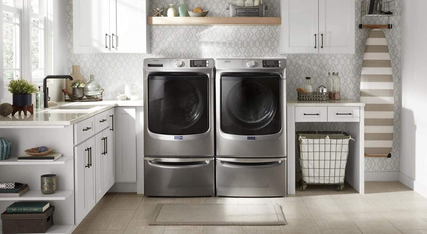 White laundry room with silver washer dryer pair
