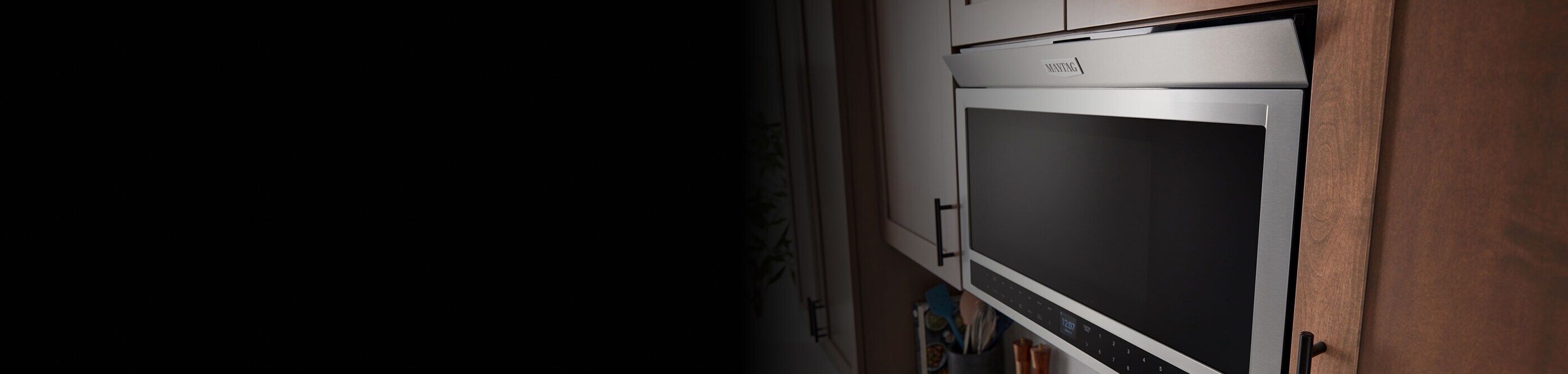 Maytag® over-the-range microwave in brown cabinetry