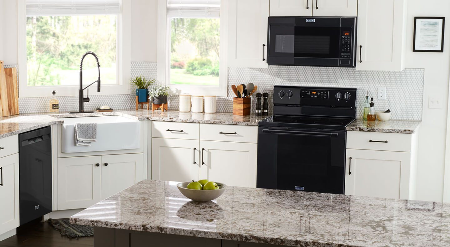 Black over-the-range Maytag® microwave above a Maytag® electric range