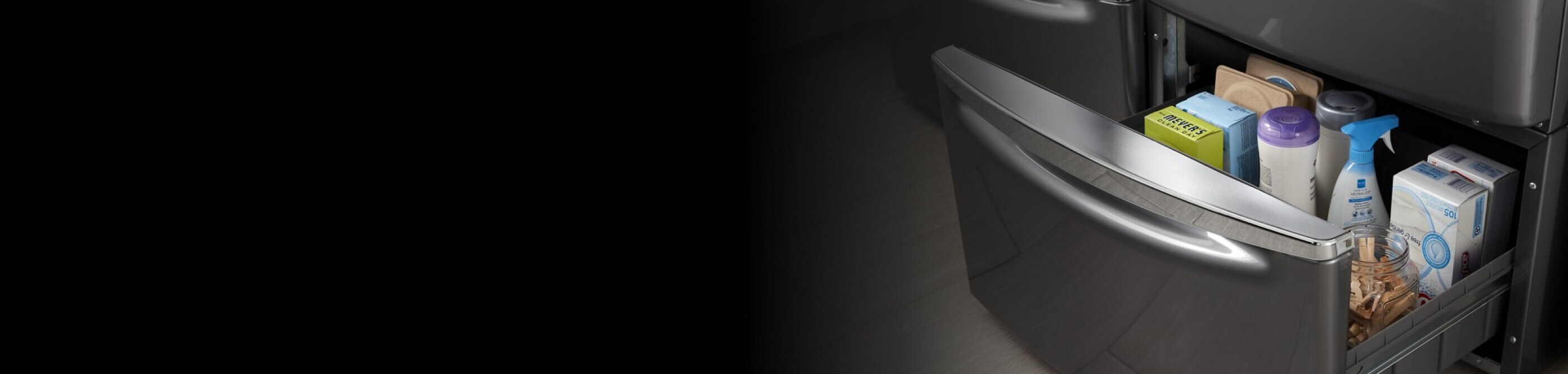 Close-up of open laundry pedestal drawer with laundry supplies inside