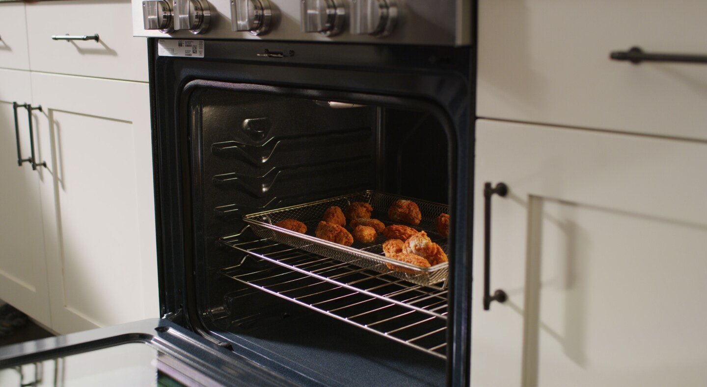 Food in air fry basket in oven