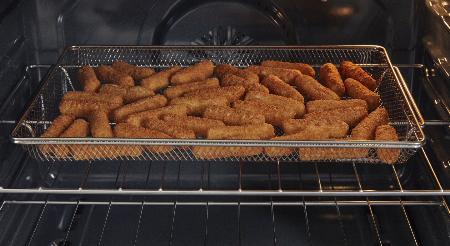 Mozzarella sticks in air fryer basket Mozzarella sticks in air fryer basket