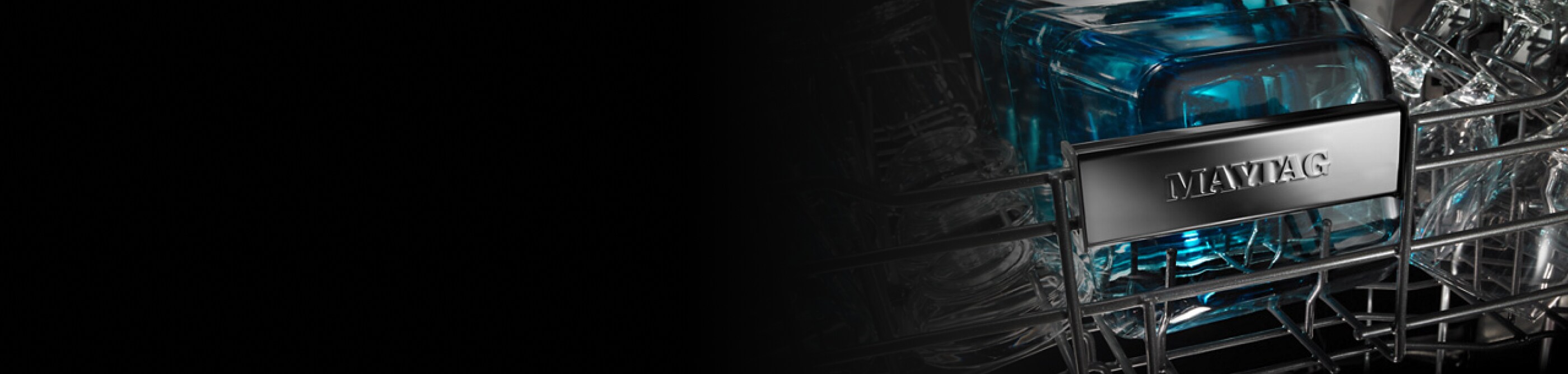 A closeup of the upper rack of the interior of a Maytag® dishwasher.