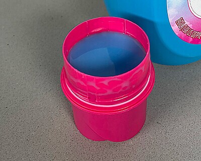 Close-up of fabric softener poured into a cap