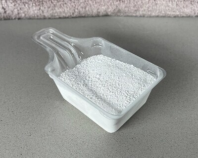 Powdered detergent in a scoop