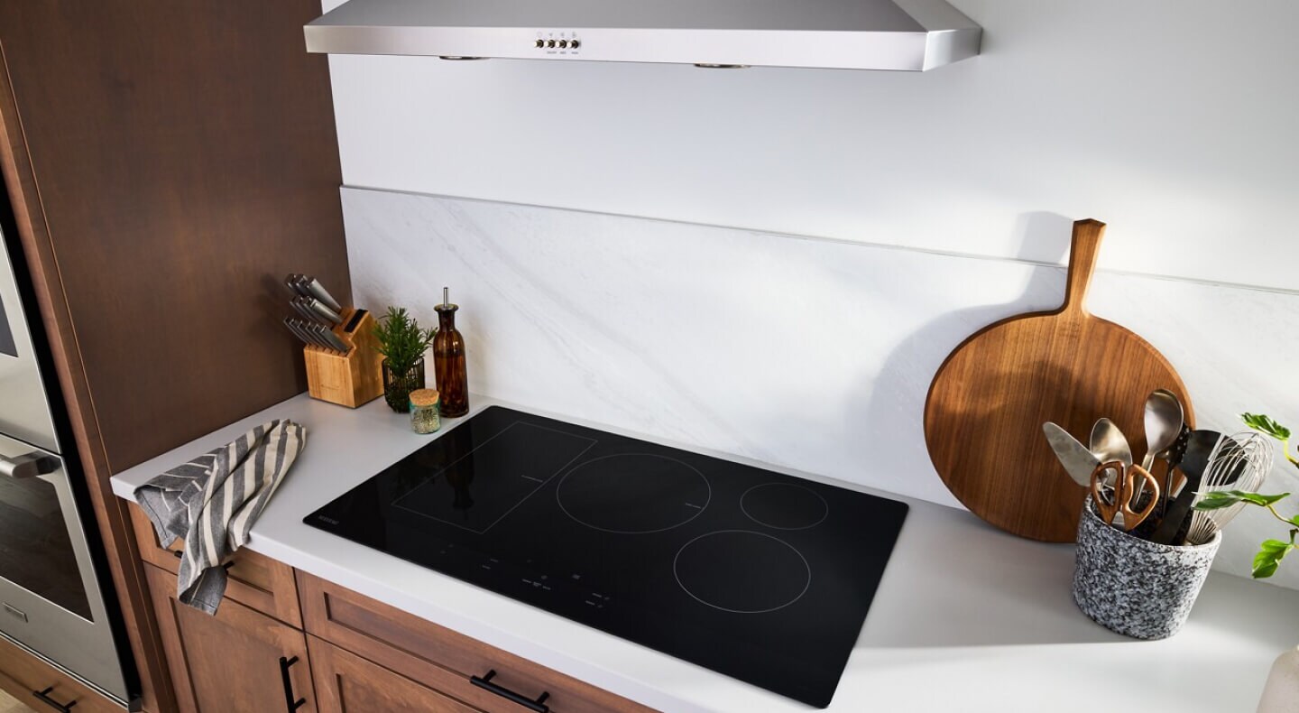 A kitchen with a Maytag® induction cooktop
