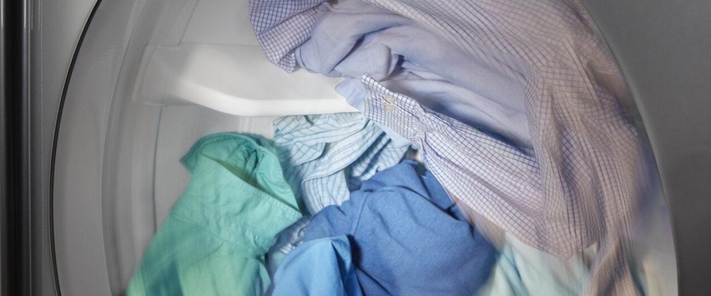 Button-up shirts tumbling inside a dryer Button-up shirts tumbling inside a dryer