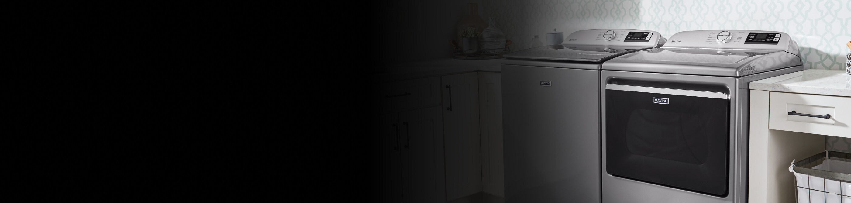 Maytag® top-load washer and dryer pair in white cabinetry