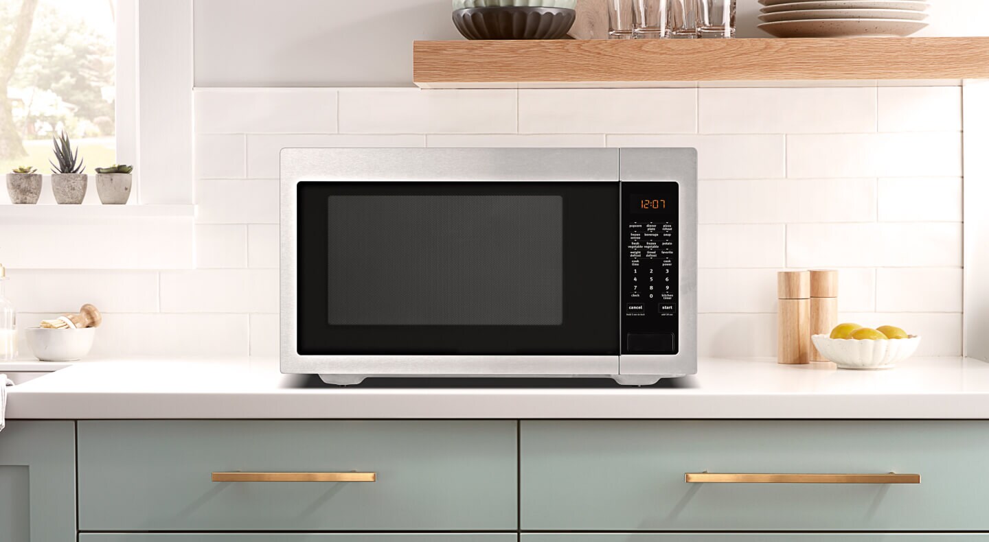 Stainless steel microwave on a countertop
