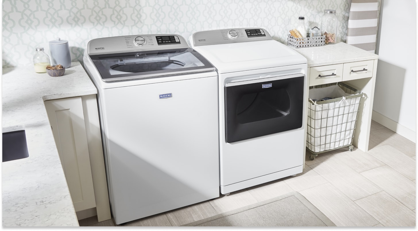 White top-load Maytag® laundry pair between laundry room cabinetry White top-load Maytag® laundry pair between laundry room cabinetry