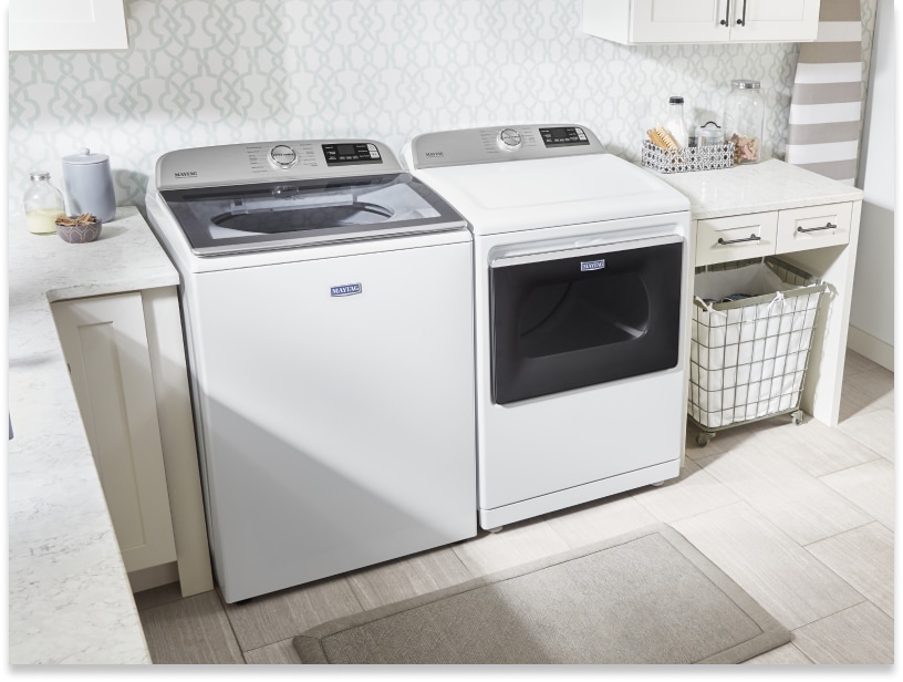 White top-load Maytag® laundry pair between laundry room cabinetry White top-load Maytag® laundry pair between laundry room cabinetry
