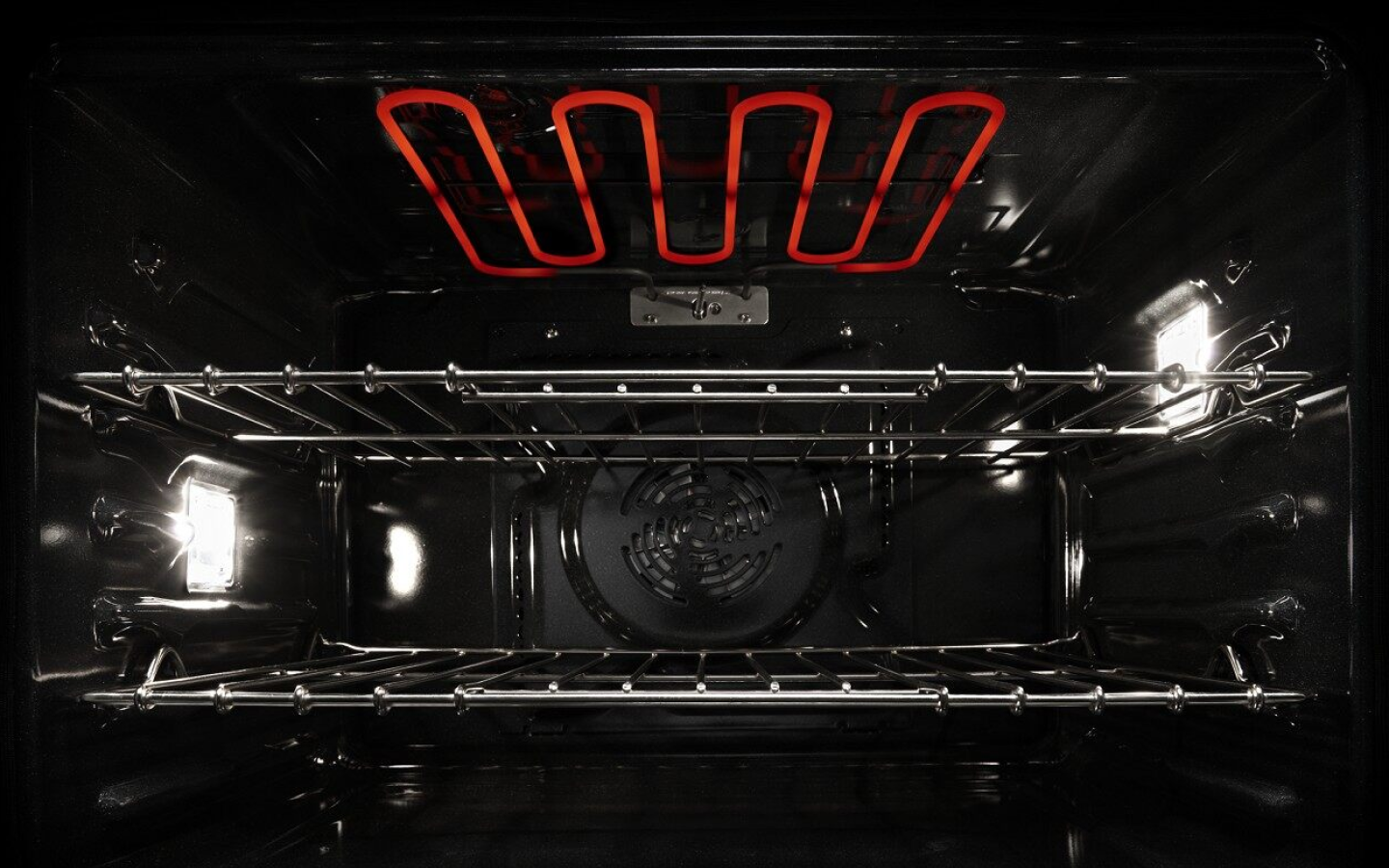 View of the inside of an active oven with red hot coils View of the inside of an active oven with red hot coils