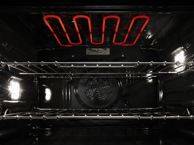 View of the inside of an active oven with red hot coils View of the inside of an active oven with red hot coils