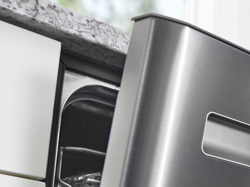 A closeup of an open dishwasher