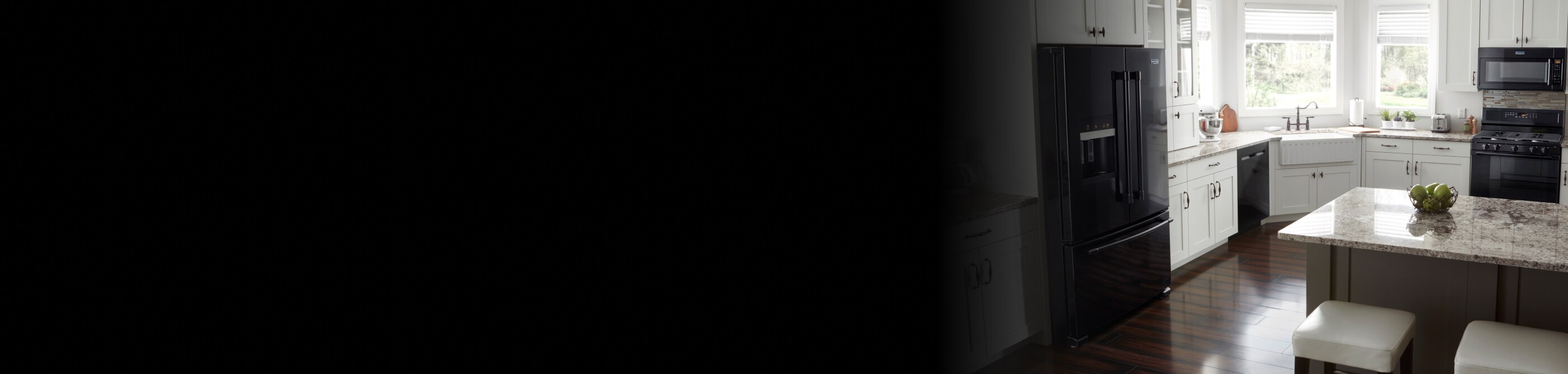 Black Maytag® French door refrigerator in a kitchen with white cabinetry