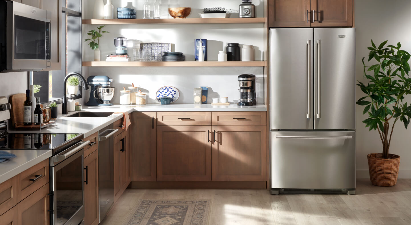  A kitchen with open shelving and stainless appliances