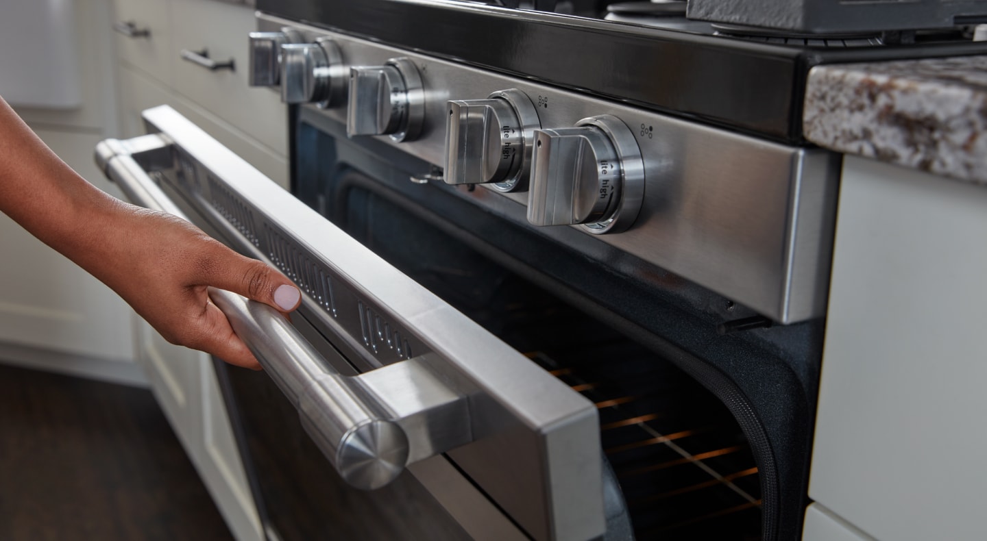 Person opening oven door Person opening oven door