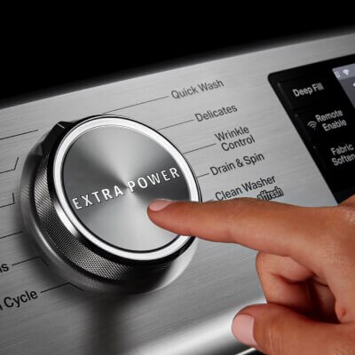 Person choosing Extra Power on a washing machine
