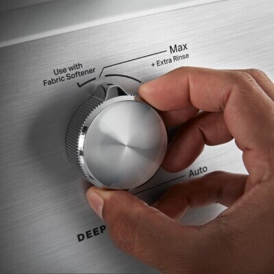 Person making a selection on a washing machine