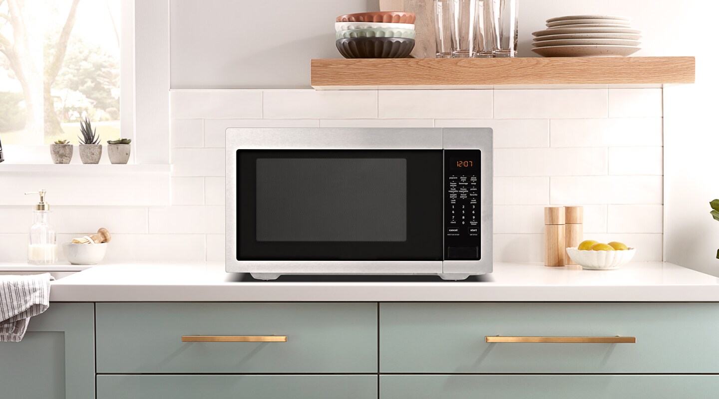 A microwave on top of a light-colored countertop