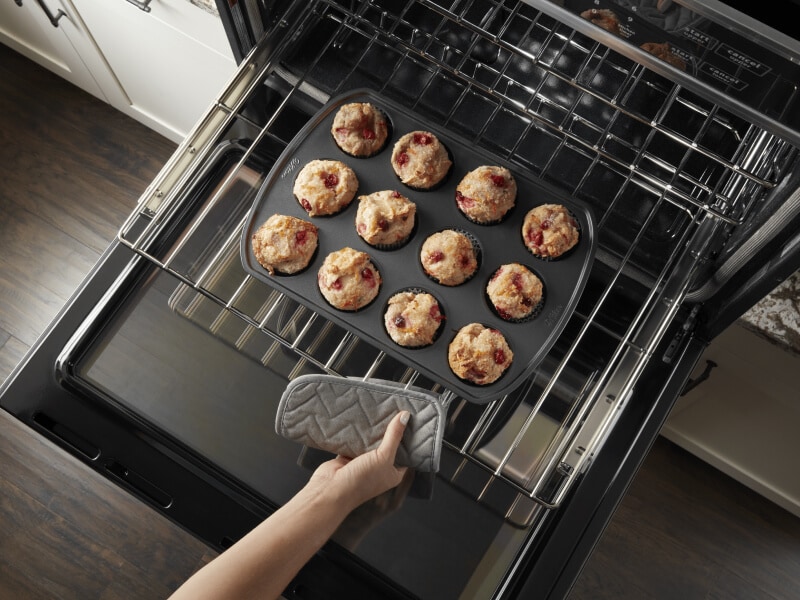 An overhead view of a Maytag® stove rack with a muffin pan