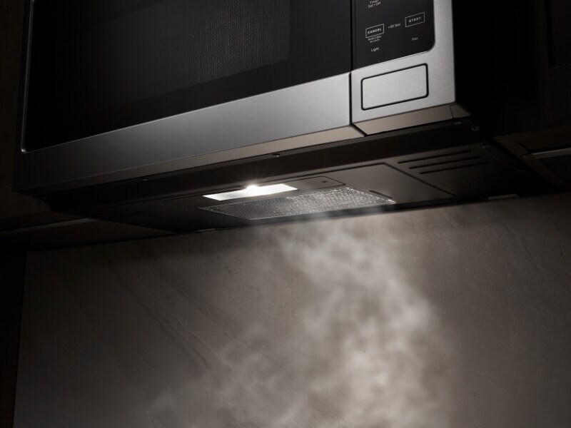 A close up of a Maytag® over-the-range microwave with ventilation