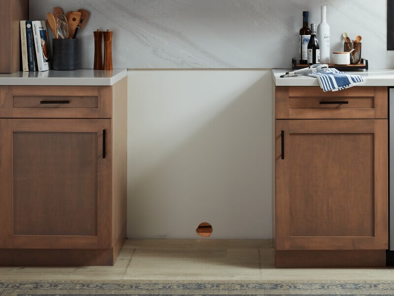 An open space to place a stove between cabinets