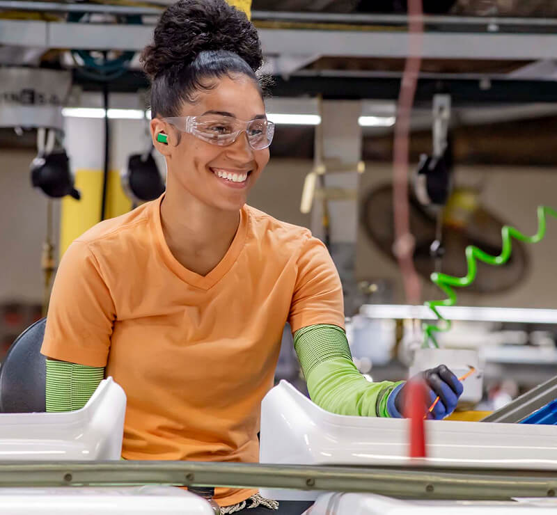 Person assembling Maytag® appliance components in a factory