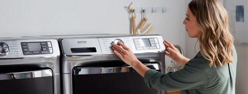 Woman setting Maytag dryer