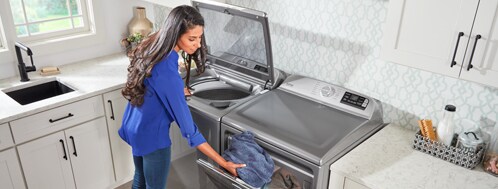 Woman loading Maytag dryer