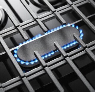 Blue flames simmering on a gas cooktop