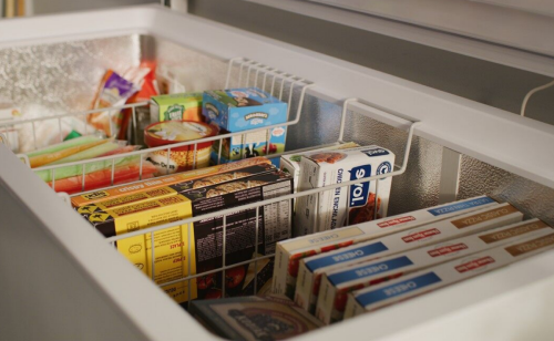 Close-up of chest freezer storage baskets full of food