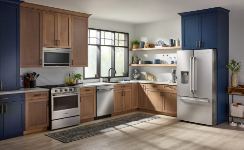 A bright, modern kitchen filled with sunlight and stainless appliances