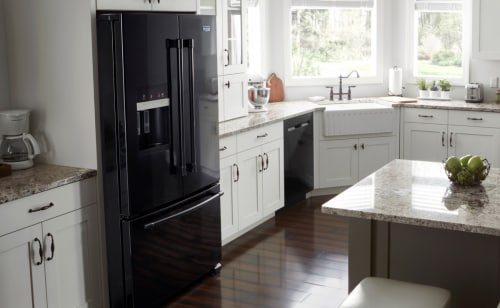 Black Maytag® French door refrigerator in a kitchen with white cabinetry