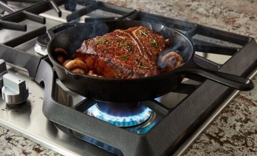 Steak cooking on a gas range