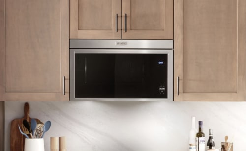 Maytag® over-the-range microwave in light brown cabinetry