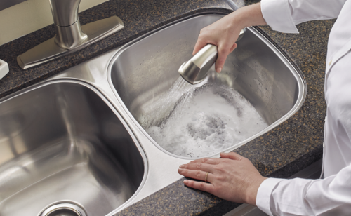 Person rinsing kitchen sink