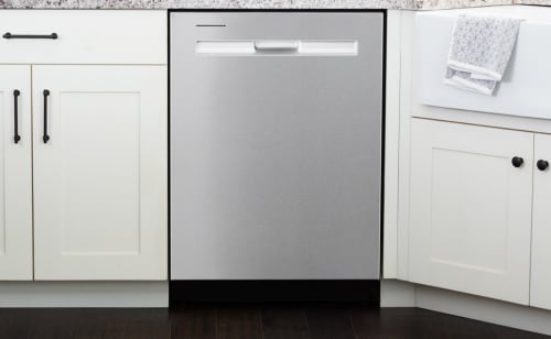 A Maytag® dishwasher surrounded by white cabinetry