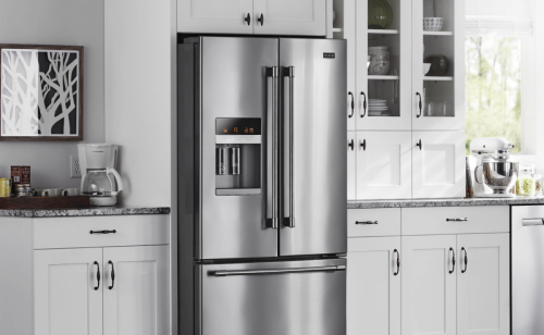 Side-by-side refrigerator from Maytag and a coffee pot on the adjacent counter