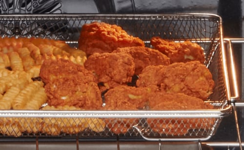 Fried chicken and fries in an air fry basket
