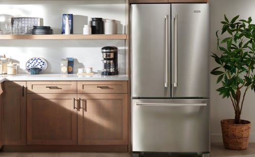 Stainless steel Maytag® French Door Refrigerator next to house plant
