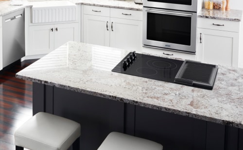 Black cooktop on white countertop