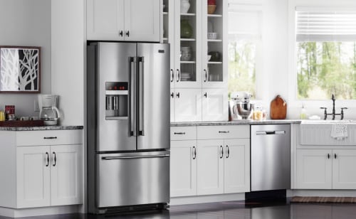 Farmhouse style kitchen featuring a stainless steel French door refrigerator