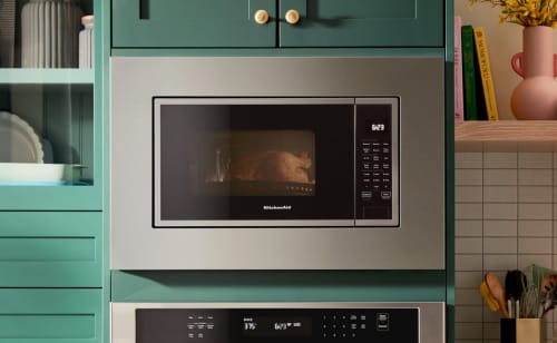Microwave built into cabinetry with a trim kit