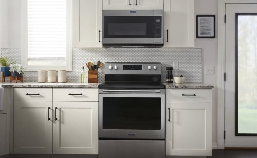 Maytag® over-the-range microwave above a Maytag® electric range